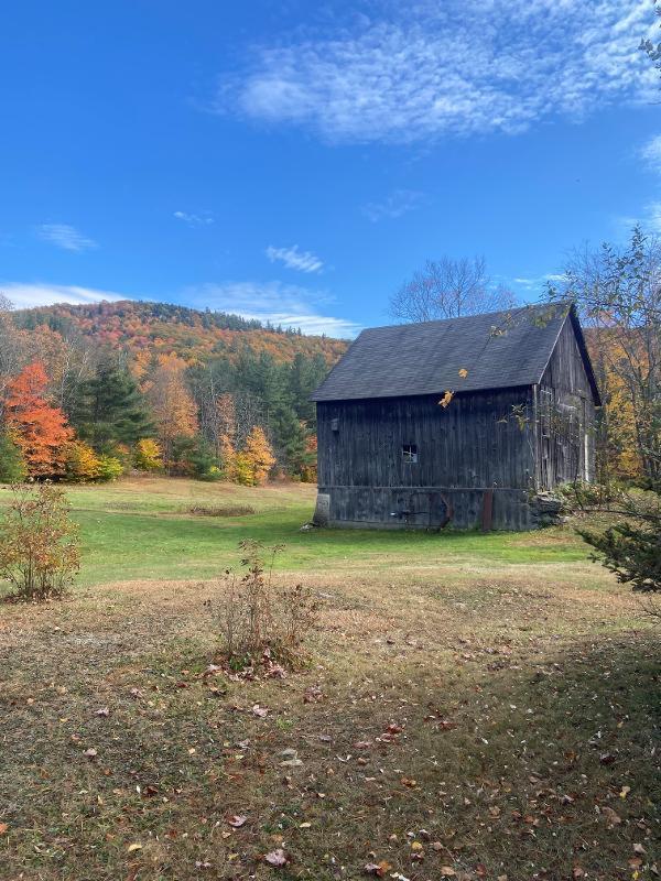 small barn in a field in fall